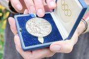 Front side of Frank Shakespeare's Olympic gold medal